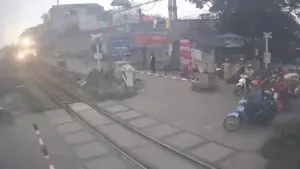 Vừa dùng điện thoại vừa 'cướp đường', xe máy bị tàu SE8 húc văng